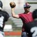 Dexter High School head football coach Ken Koenig looks to pass the ball during a practice drill at the school on Friday, August 16, 2013. Melanie Maxwell | AnnArbor.com